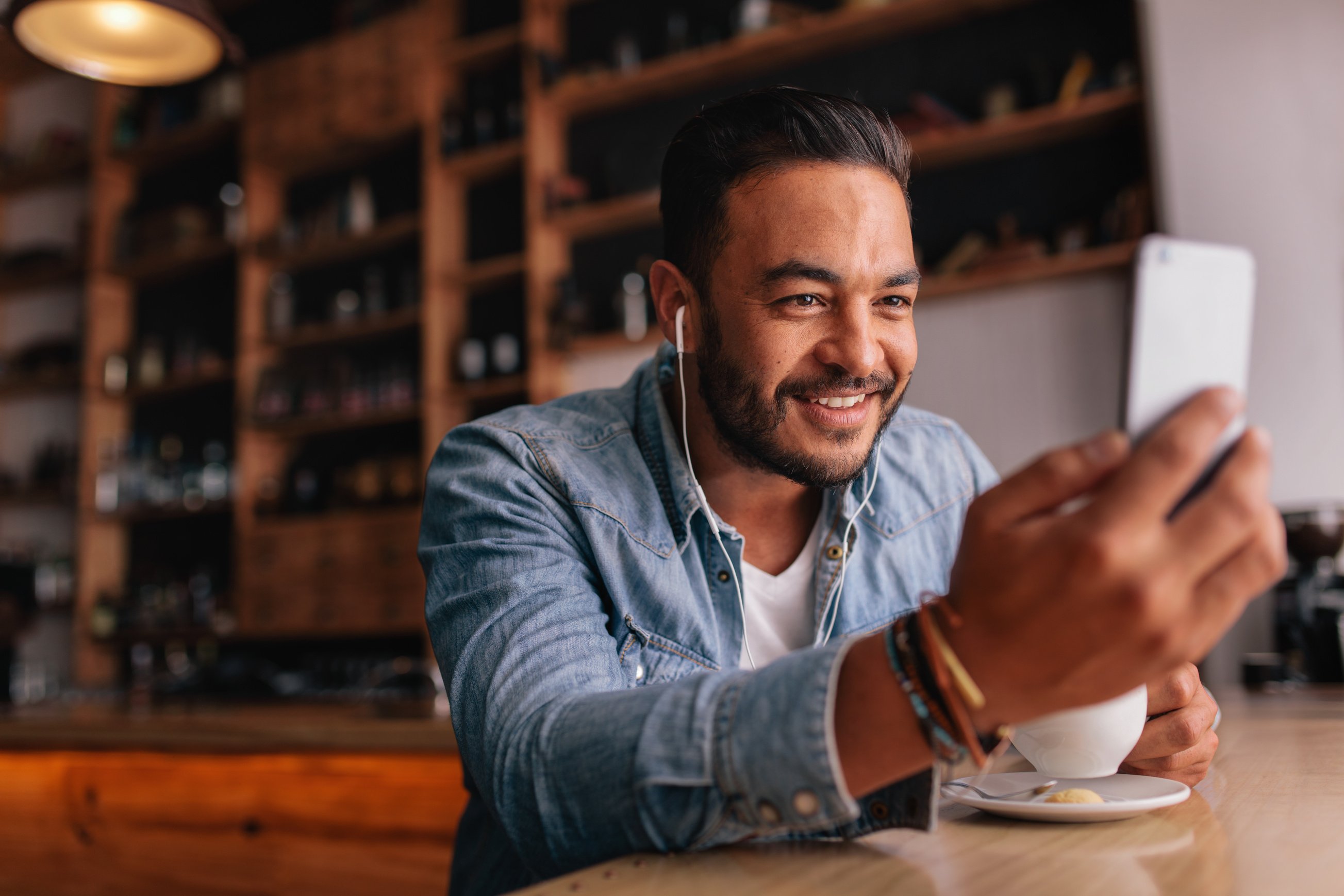 Man Sitting at Cafe Making Video Call